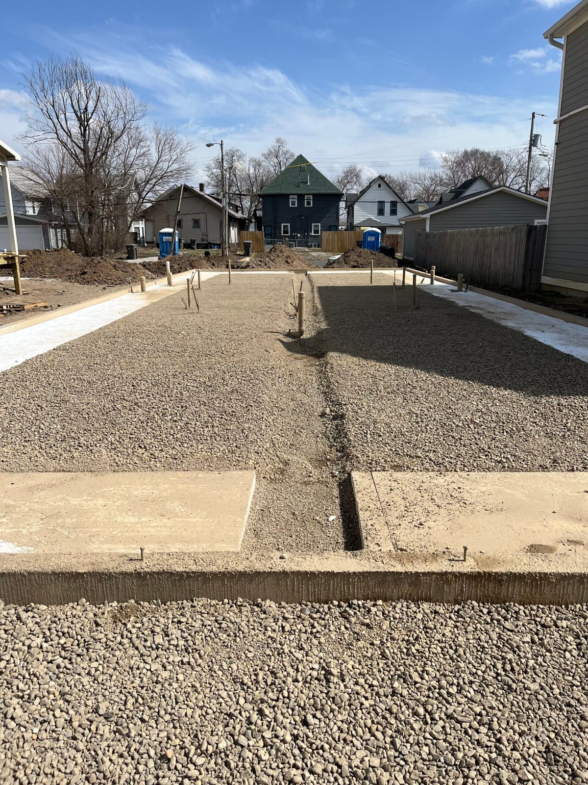 Compacted stone base prepared inside poured footings